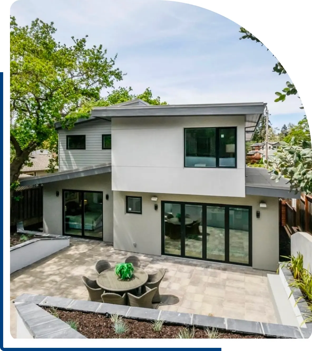 Group 1321314634 A house with a patio and table in it