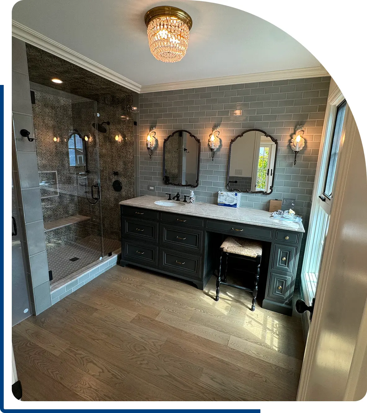 A bathroom with a sink, mirror and shower.